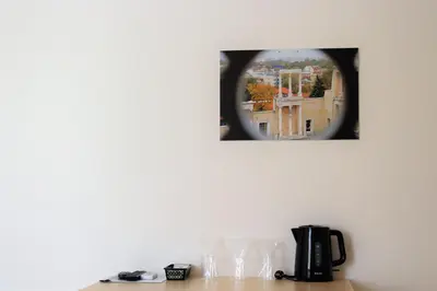 a mirror on a wall above a table with glasses at Youth Centre Plovdiv in Plovdiv