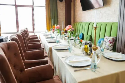 a long table in a room with chairs and tablesktop at Valentina Castle in Ognyanovo