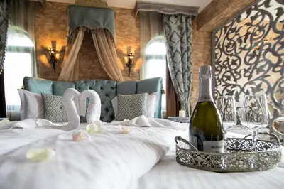 a bedroom with a bed with a bottle of champagne at Valentina Castle in Ognyanovo