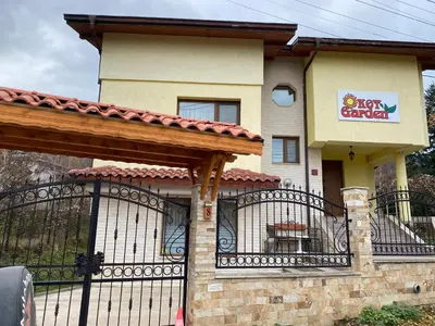 a house with a gate in front of it at Kot Garden Guest House in Sapareva Banya