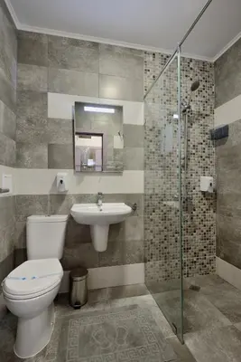 a bathroom with a toilet and a sink at Hotel Hello Hissar in Hisarya