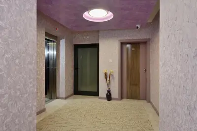 a hallway with a vase with yellow flowers in it at Hotel Hello Hissar in Hisarya