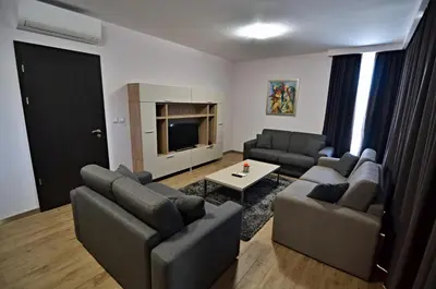 a living room with two couches and a television at Guest House Colori in Tsigov Chark