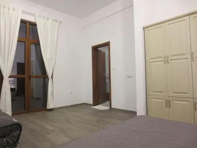 a room with a bed and a door and a door at Boomerang Guest House in Apriltsi