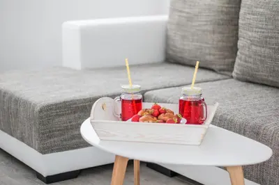 a tray of fruit on a table next to a couch at Domus Apartments City Center with Parking in Plovdiv