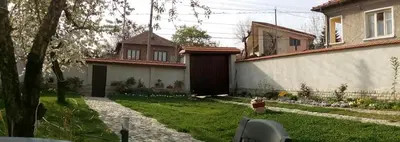 a house with a yard with a fence and a house at Bobekova Kashta in Panagyurishte