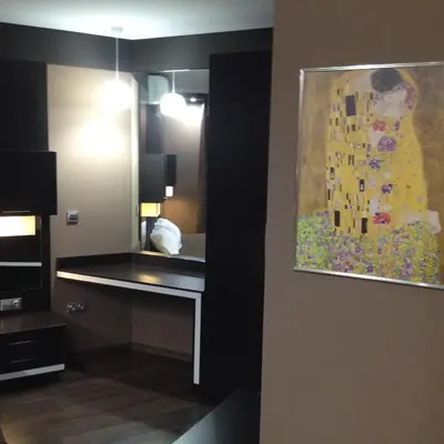 a hotel room with a painting of a woman on the wall at Studio Mountain Dreams Deluxe in Sapareva Banya