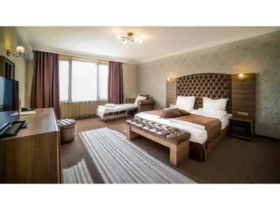 a hotel room with a bed and a television at Park Hotel and SPA Vella Hills in Velingrad