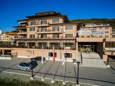 a building with a car parked in front of it at Park Hotel and SPA Vella Hills in Velingrad