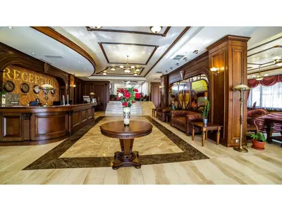 a lobby with a reception desk and a table with flowers at Park Hotel and SPA Vella Hills in Velingrad