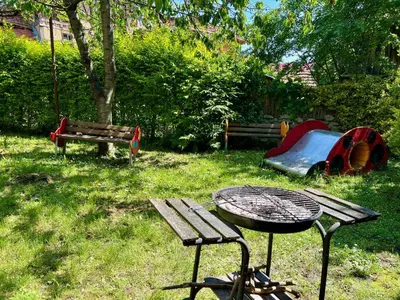 a park with a picnic table and a playground at Pamir Guest House in Shipkovo