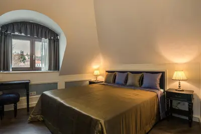 a bedroom with a bed with two tables and a window at Boutique Guest House Coco in Plovdiv