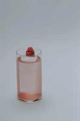 a raspberry sitting on top of a glass of water at Boutique Guest House Coco in Plovdiv