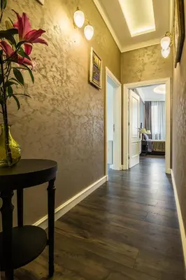 a hallway with a table and a vase of flowers at Boutique Guest House Coco in Plovdiv