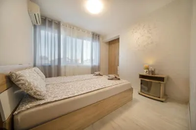 a bedroom with a large bed with a window at Old Town Apartment in Plovdiv