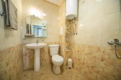 a bathroom with a toilet and a sink at Old Town Apartment in Plovdiv