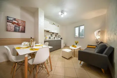 a kitchen and living room with a table and a couch at Old Town Apartment in Plovdiv