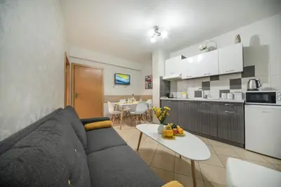 a living room and kitchen with a couch and a table at Old Town Apartment in Plovdiv