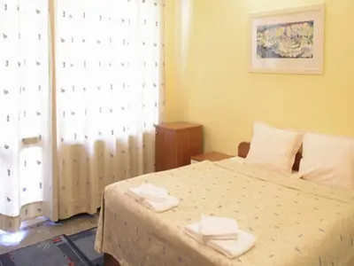 a bedroom with a bed with two towels on it at Hotel Ertancom in Blagoevgrad