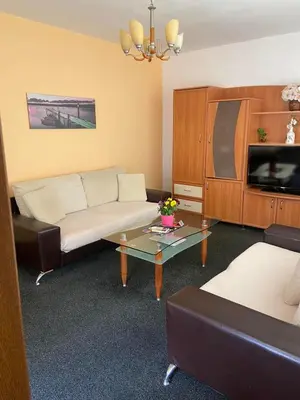 a living room with a couch and a coffee table at hotel TEDI in Asenovgrad