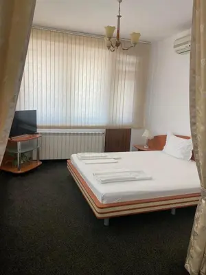 a bedroom with a large bed and a window at hotel TEDI in Asenovgrad