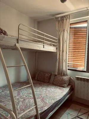 a bedroom with two bunk beds and a window at The Clock house in Samokov