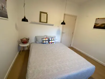 a small bedroom with a bed in a room at The Clock house in Samokov
