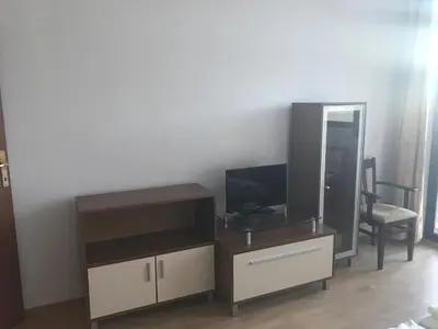 a living room with a tv and a entertainment center at Flora Apartment 619 in Borovets