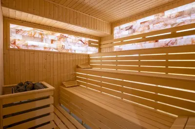 a sauna with wood paneling and a wooden at Premier Luxury Mountain Resort in Bansko