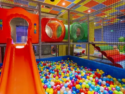 a play room with a ball pit and a slide at Premier Luxury Mountain Resort in Bansko