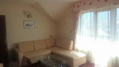 a living room with a couch and a window at Martin Club Hotel in Bansko