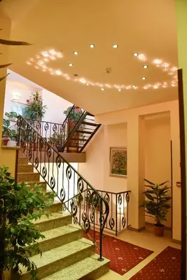 a staircase in a house with lights on the ceiling at Martin Club Hotel in Bansko