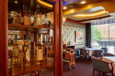 a bar with many bottles of alcohol on a shelf at Hotel Leipzig in Plovdiv