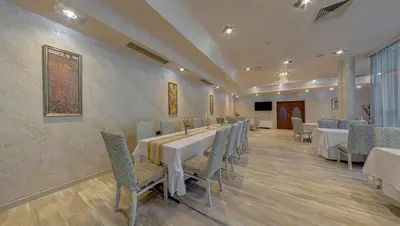 a dining room with white tables and chairs at Hotel Leipzig in Plovdiv