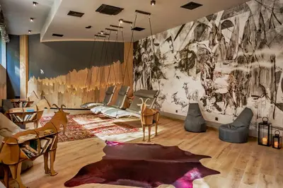 a room with chairs and a wall with a mural at Kashmir Wellness & SPA Hotel Adults Only in Velingrad