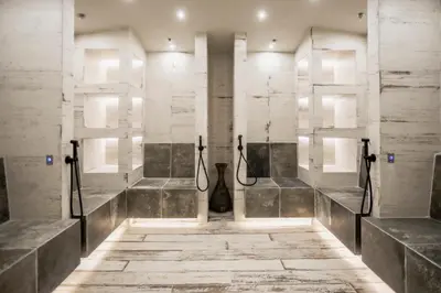 a bathroom with a shower with concrete walls at Kashmir Wellness & SPA Hotel Adults Only in Velingrad