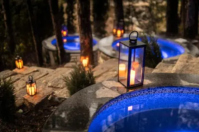 a group of candles and lanterns on a swimming pool at Kashmir Wellness & SPA Hotel Adults Only in Velingrad