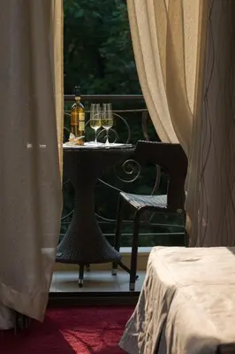 a table with two glasses of wine on a balcony at Famous House in Plovdiv