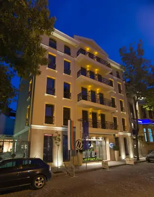 a car parked in front of a building at night at Famous House in Plovdiv