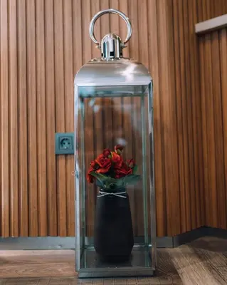 a glass flask with a vase with red roses in it at Hotel BLVD 7 in Plovdiv