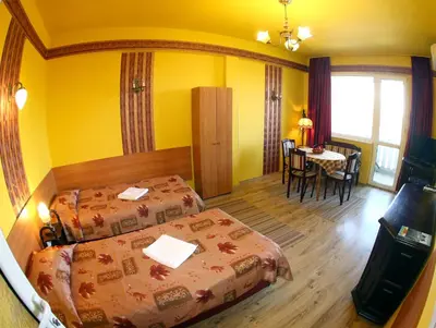 a hotel room with two beds and a table at COLORED HOUSE Apartments in Sofia