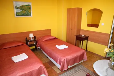 two beds in a room with yellow walls at COLORED HOUSE Apartments in Sofia