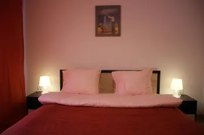 a bedroom with a bed with two pink pillows at PM Services Semiramida Apartments in Borovets