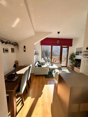 a large living room with a table and a couch at PM Services Semiramida Apartments in Borovets