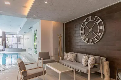 a living room with a large clock on the wall at Spa Hotel Persenk in Devin