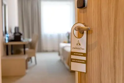 a sign on a door in a hotel room at Spa Hotel Persenk in Devin