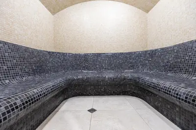 a room with black and white tiles on the wall at Spa Hotel Persenk in Devin