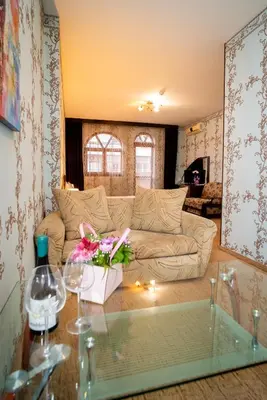 a living room with a couch and a glass table at Globus Hotel in Plovdiv