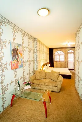 a living room with a couch and a table at Globus Hotel in Plovdiv