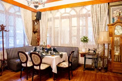 a dining room with a table and chairs at Globus Hotel in Plovdiv